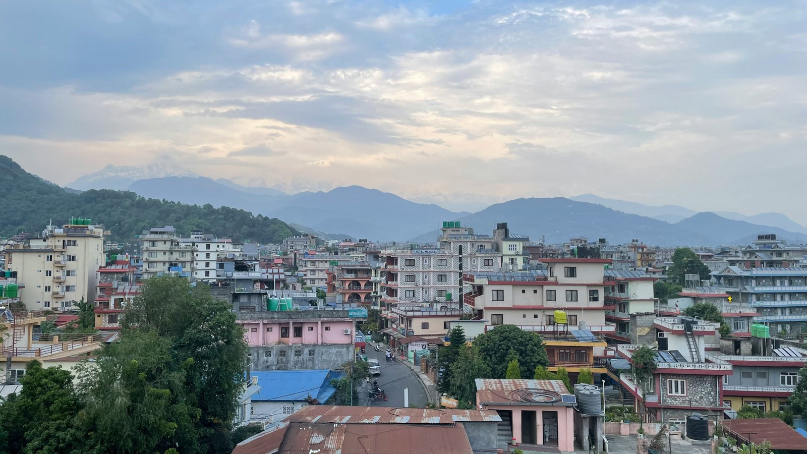 a view of a city with mountains in the background